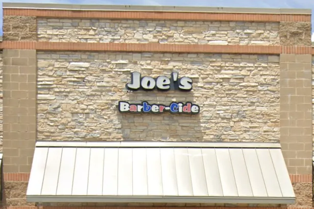 Joe’s Barber Cide storefront sign above a light-colored awning.